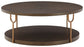 Ashley Express - Brazburn Round Cocktail Table at Towne & Country Furniture (AL) furniture, home furniture, home decor, sofa, bedding