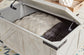Ashley Express - Carynhurst Cocktail Table with Storage at Towne & Country Furniture (AL) furniture, home furniture, home decor, sofa, bedding